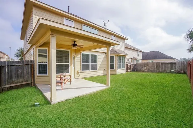 a view of house with backyard