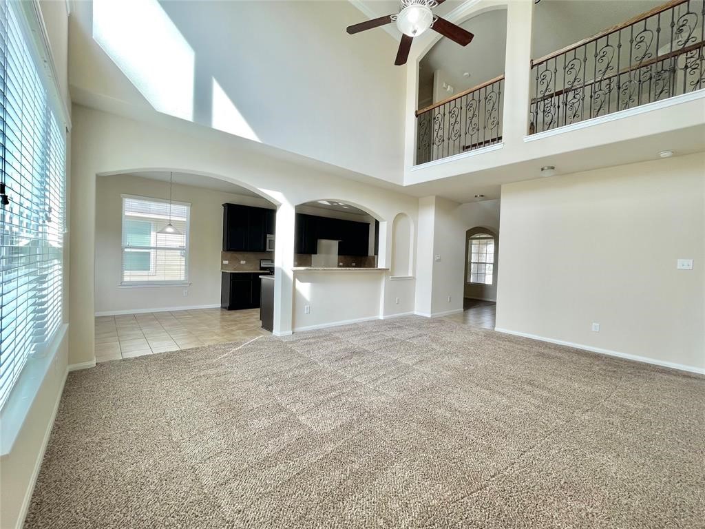 25015 Diamond Ranch Drive Katy, TX 77494 - Photo 7 of 27 a view of an empty room with a fireplace and a window
