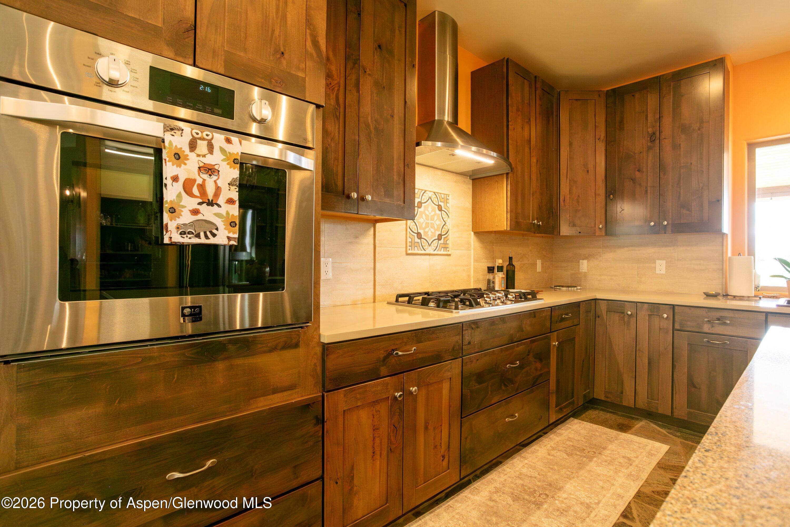 265 South Meadow Drive Rifle, CO 81650 - Photo 49 of 76 a kitchen with stainless steel appliances granite countertop a stove and a sink