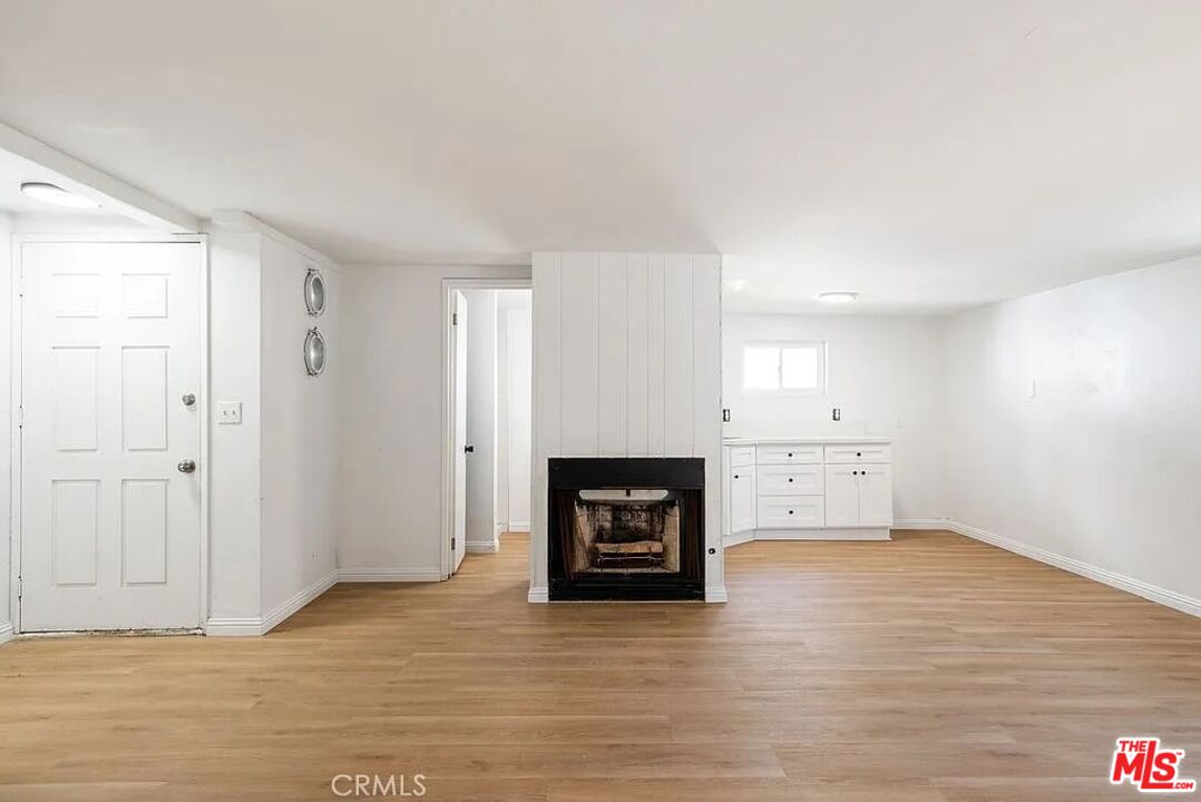 312 East Peace Street Long Beach, CA 90805 - Photo 28 of 39 a view of a livingroom with an empty space and a fireplace
