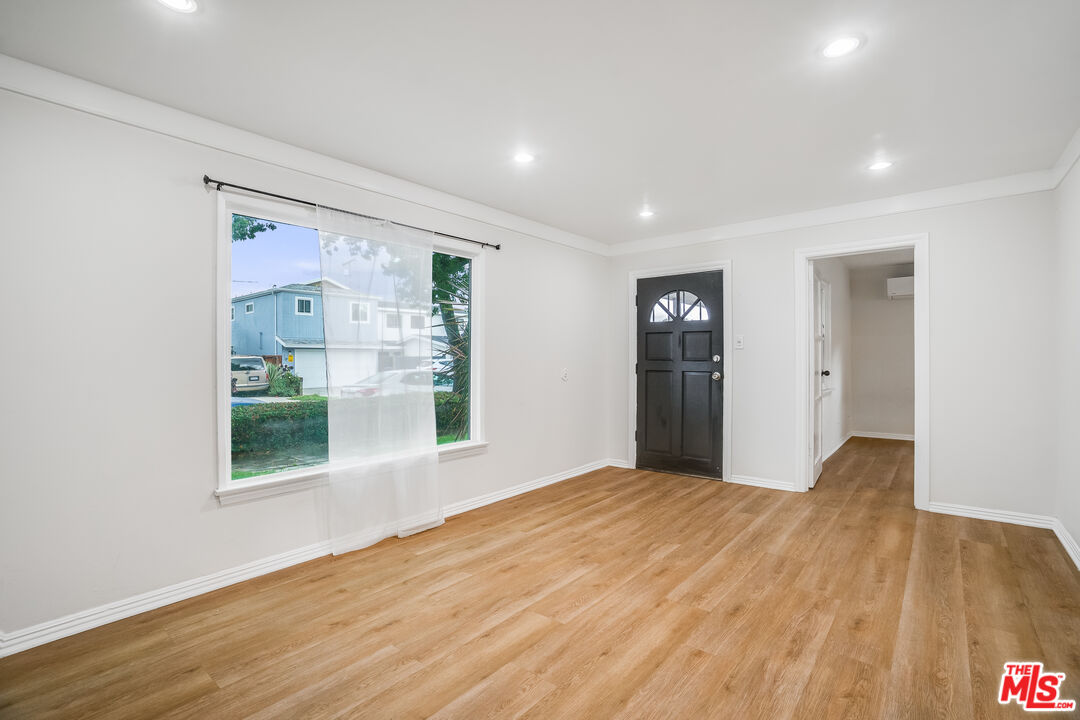 312 East Peace Street Long Beach, CA 90805 - Photo 3 of 39 a view of a big room with wooden floor and windows
