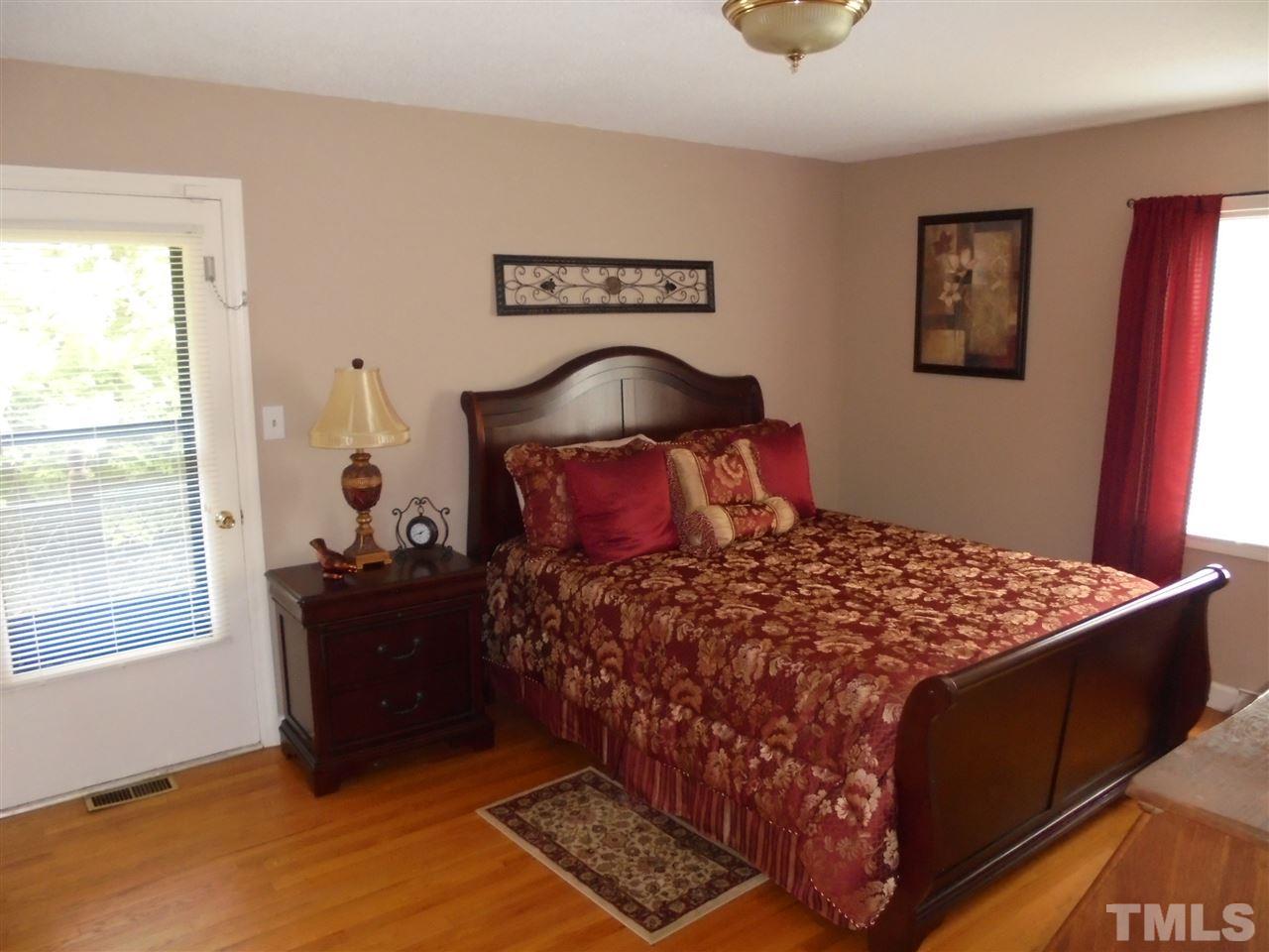 182 Dyking Road Louisburg, NC 27549 - Photo 17 of 25 This bedroom has hardwood floors and also and exterior door that opens up to a covered porch shared with the Master bedroom!