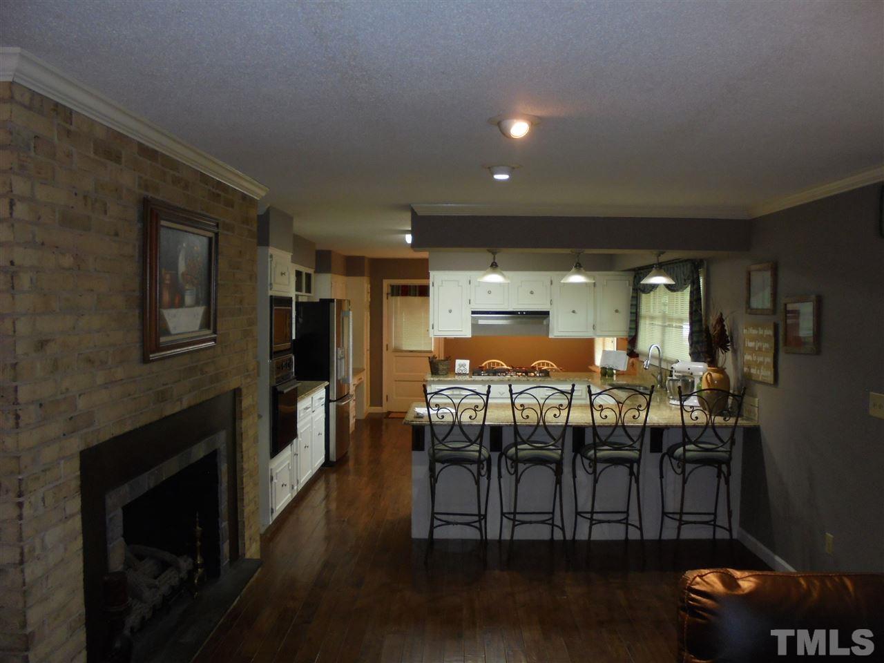 182 Dyking Road Louisburg, NC 27549 - Photo 5 of 25 Kitchen was updated with granite countertops, stainless steel appliances, tile backsplashes and maple hardwood flooring!
