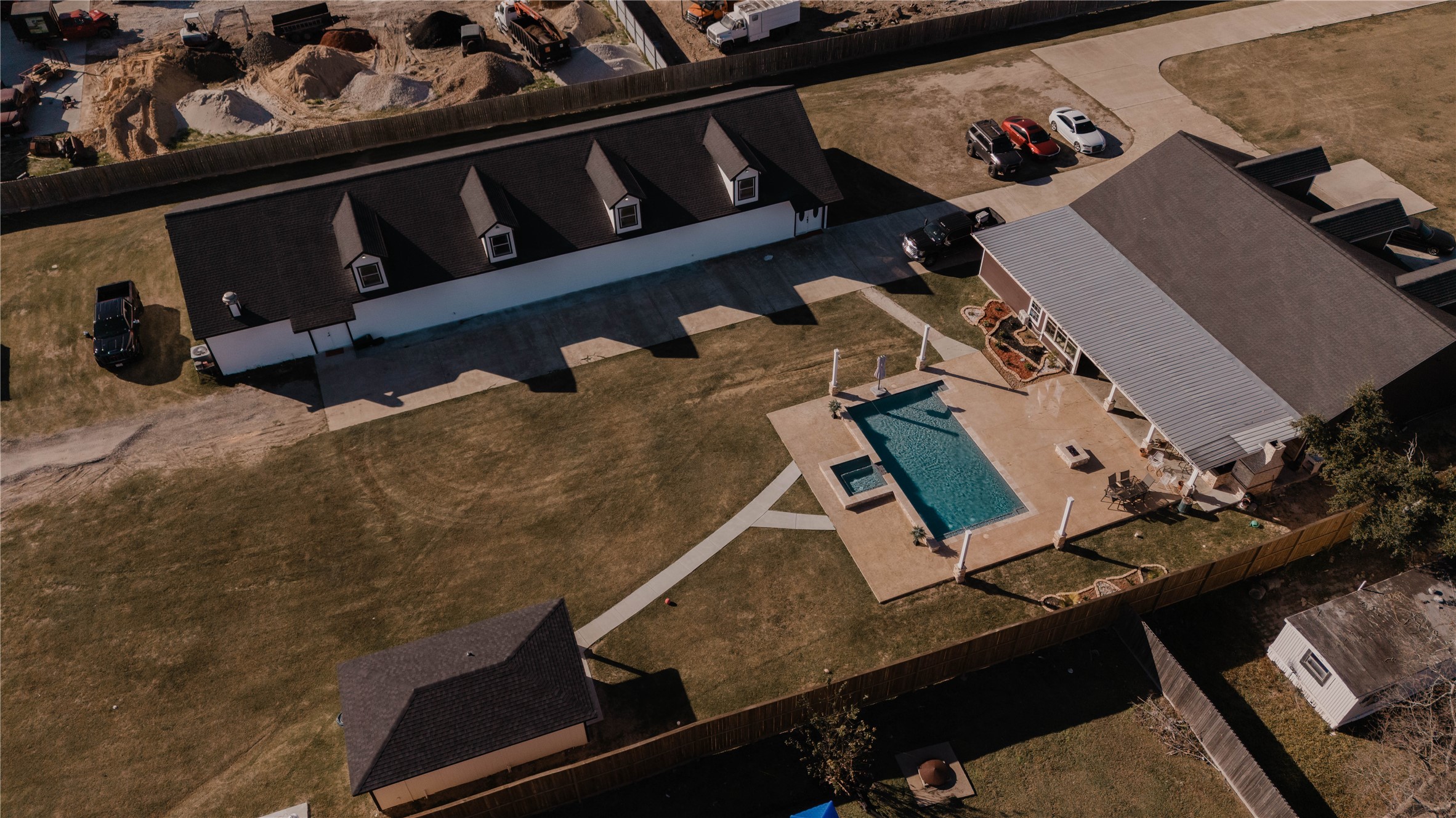 918 Fresa Road Pasadena, TX 77502 - Photo 1 of 47 This aerial photo showcases a spacious property featuring a large backyard with a swimming pool, ample patio space, and multiple buildings, including Venue Building a sizable storage or outbuilding. The area appears well-maintained and offers plenty of parking and open for expansion and room to grow.