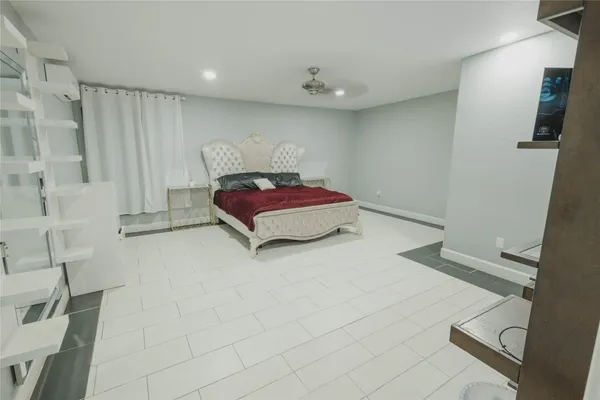 a bedroom with a bed and a chair