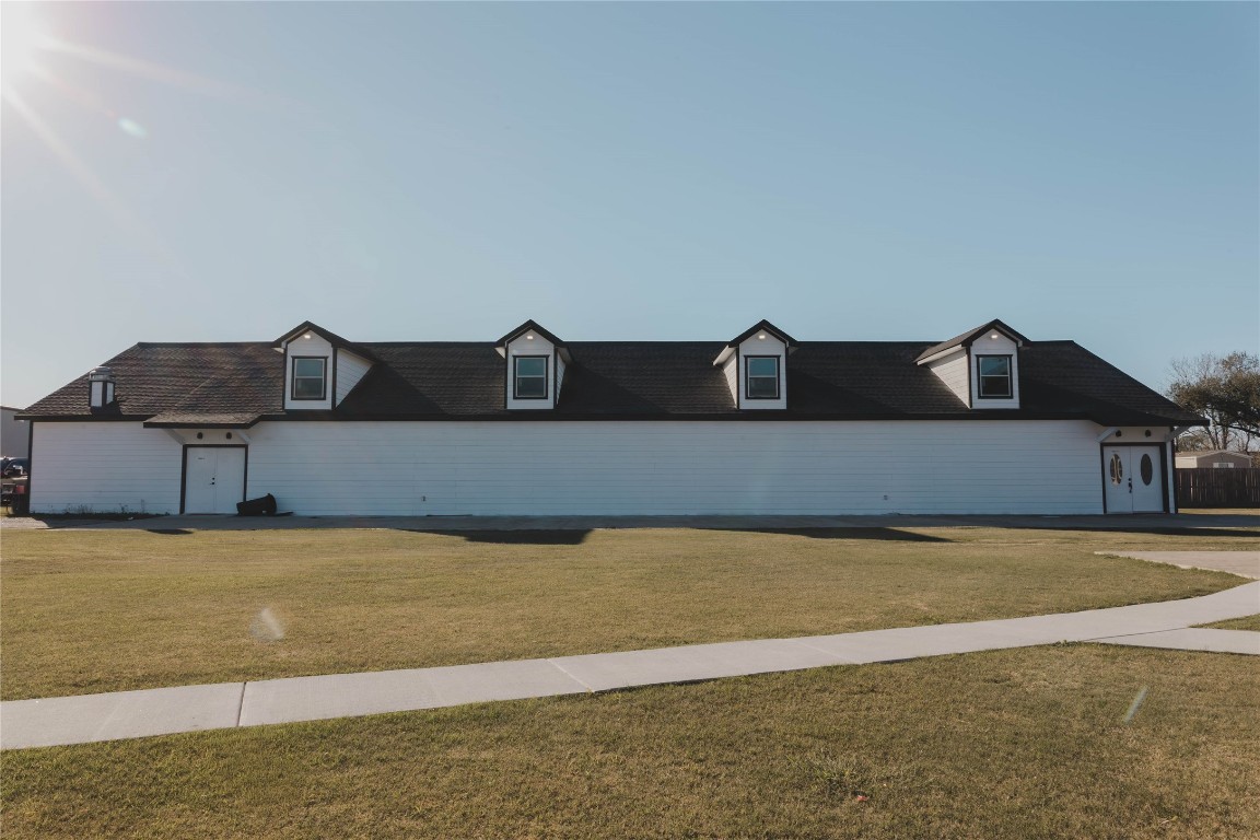 918 Fresa Road Pasadena, TX 77502 - Photo 28 of 47 Spacious Event/Venue 2 story Building with a long, white exterior and dark roof, featuring dormer windows. Large front lawn and a walkway leading to the entrance. Ideal for those seeking ample space and a classic design.