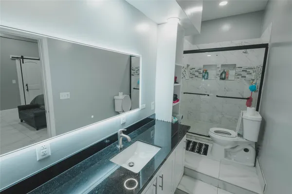 a spacious bedroom with a bed and a cabinets