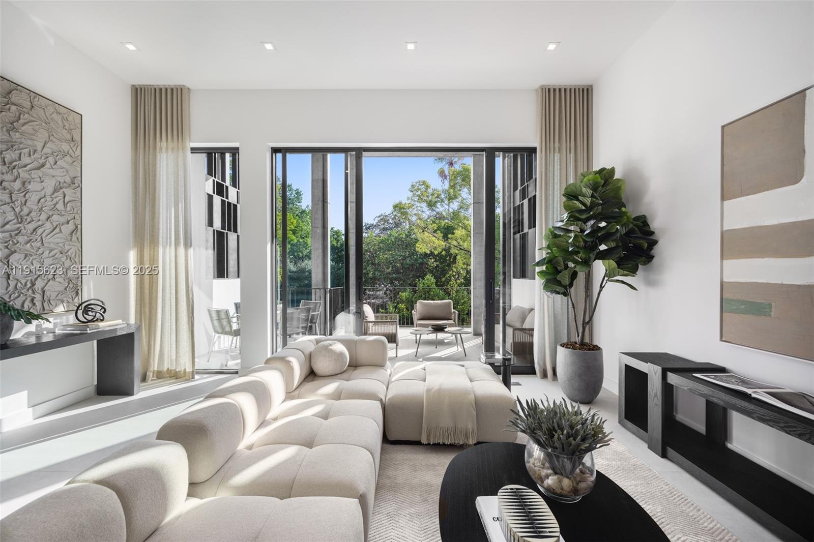 a living room with furniture and a floor to ceiling window