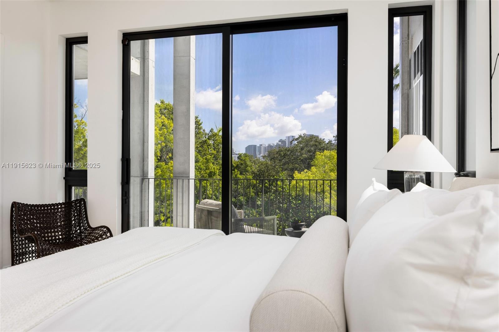 94 Southwest 28th Road, Unit 3 Miami, FL 33129 - Photo 18 of 33 a bedroom with a large bed and a large window