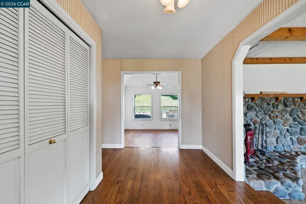 a view of hallway with wooden floor