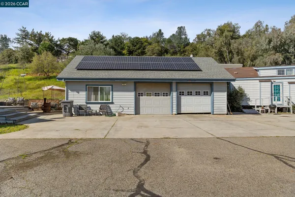 a view of a swimming pool with an outdoor seating and a garden