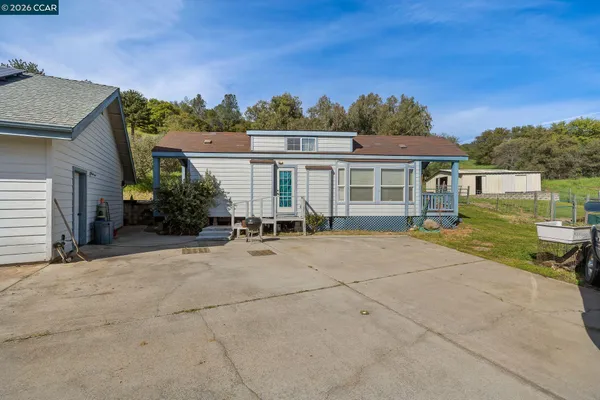 a view of a house with pool and a yard