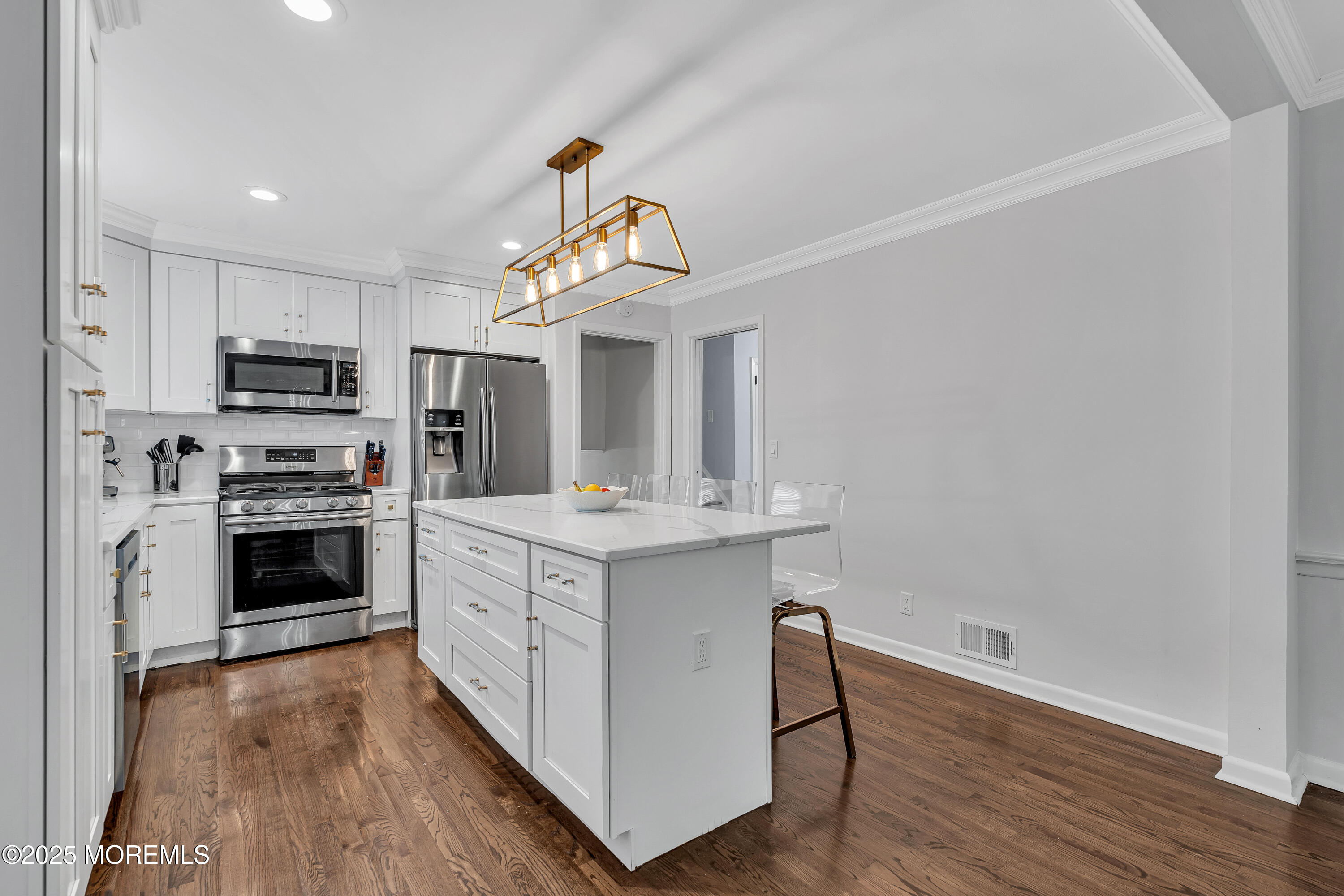 67 Beverly Road Springfield, NJ 07081 - Photo 18 of 46 a kitchen with kitchen island a stove a sink and a microwave