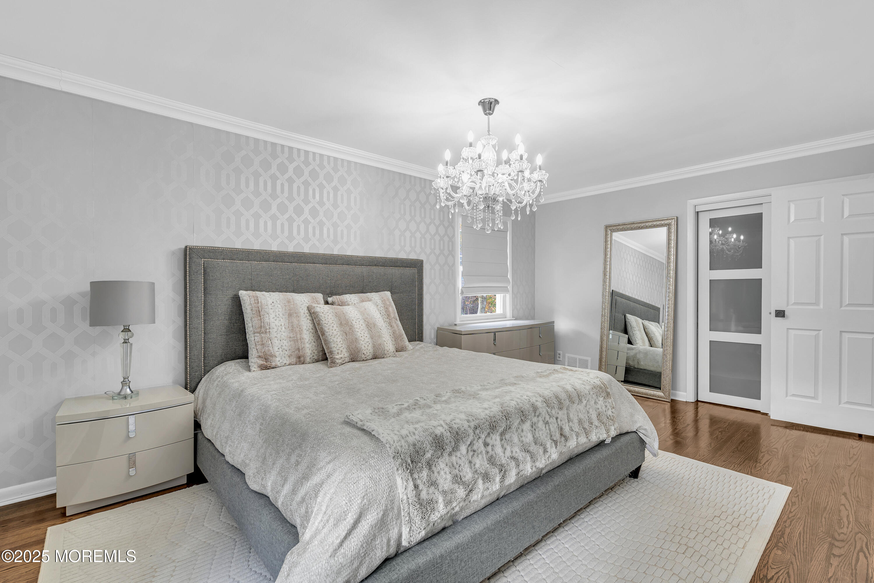 67 Beverly Road Springfield, NJ 07081 - Photo 29 of 46 a bedroom with a large bed and a chandelier