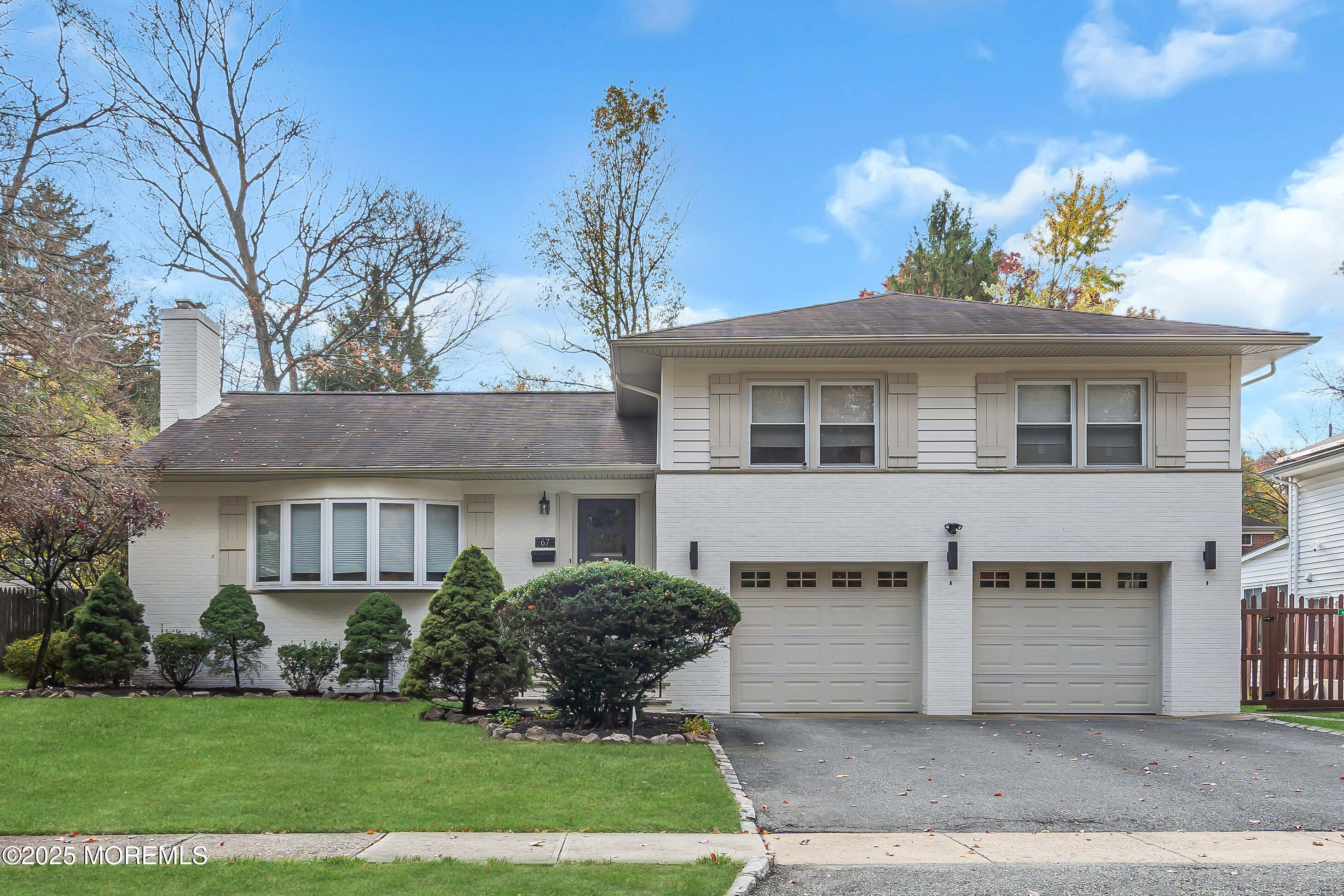 67 Beverly Road Springfield, NJ 07081 - Photo 3 of 46 a front view of a house with a yard and potted plants