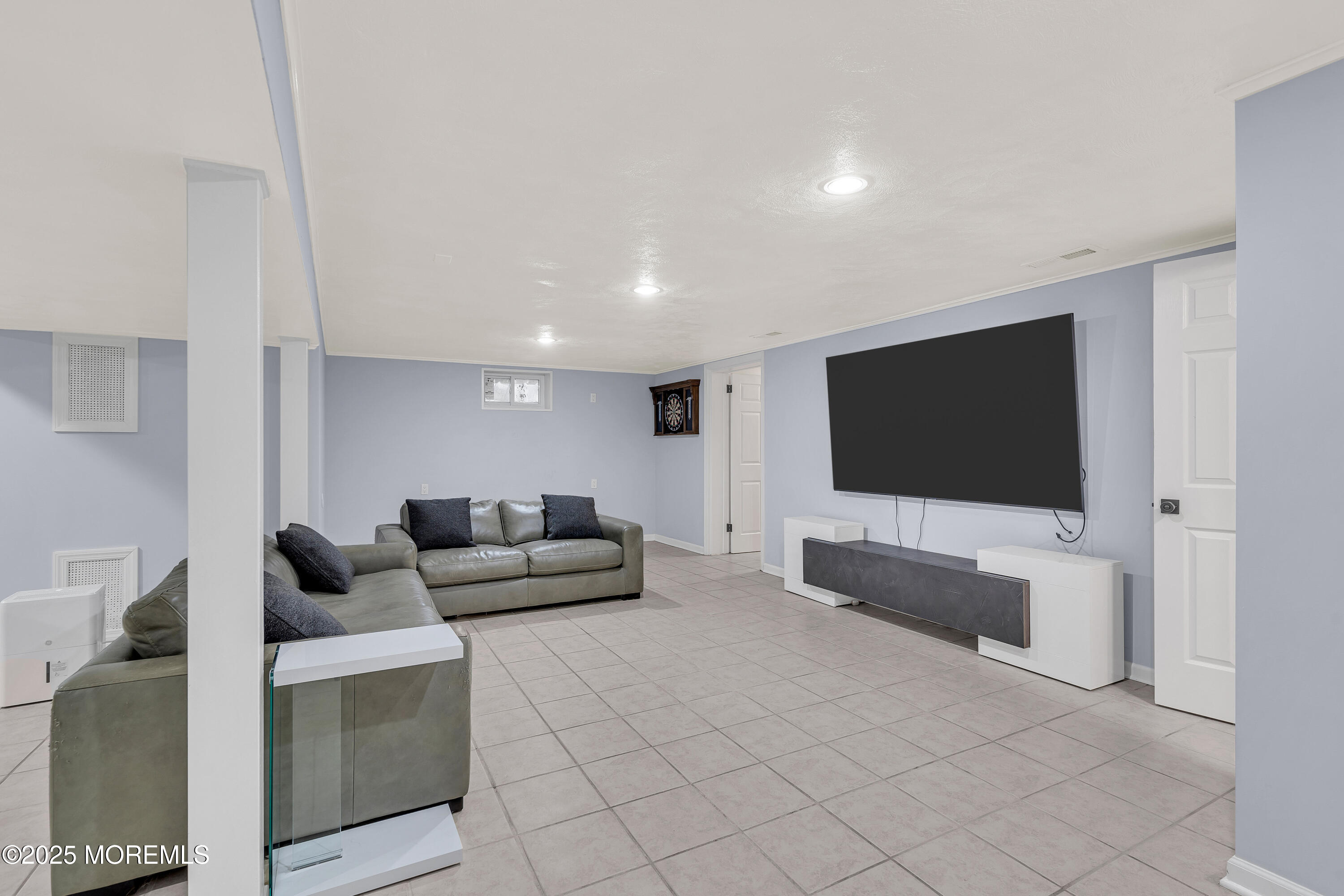 67 Beverly Road Springfield, NJ 07081 - Photo 34 of 46 a living room with furniture and a flat screen tv