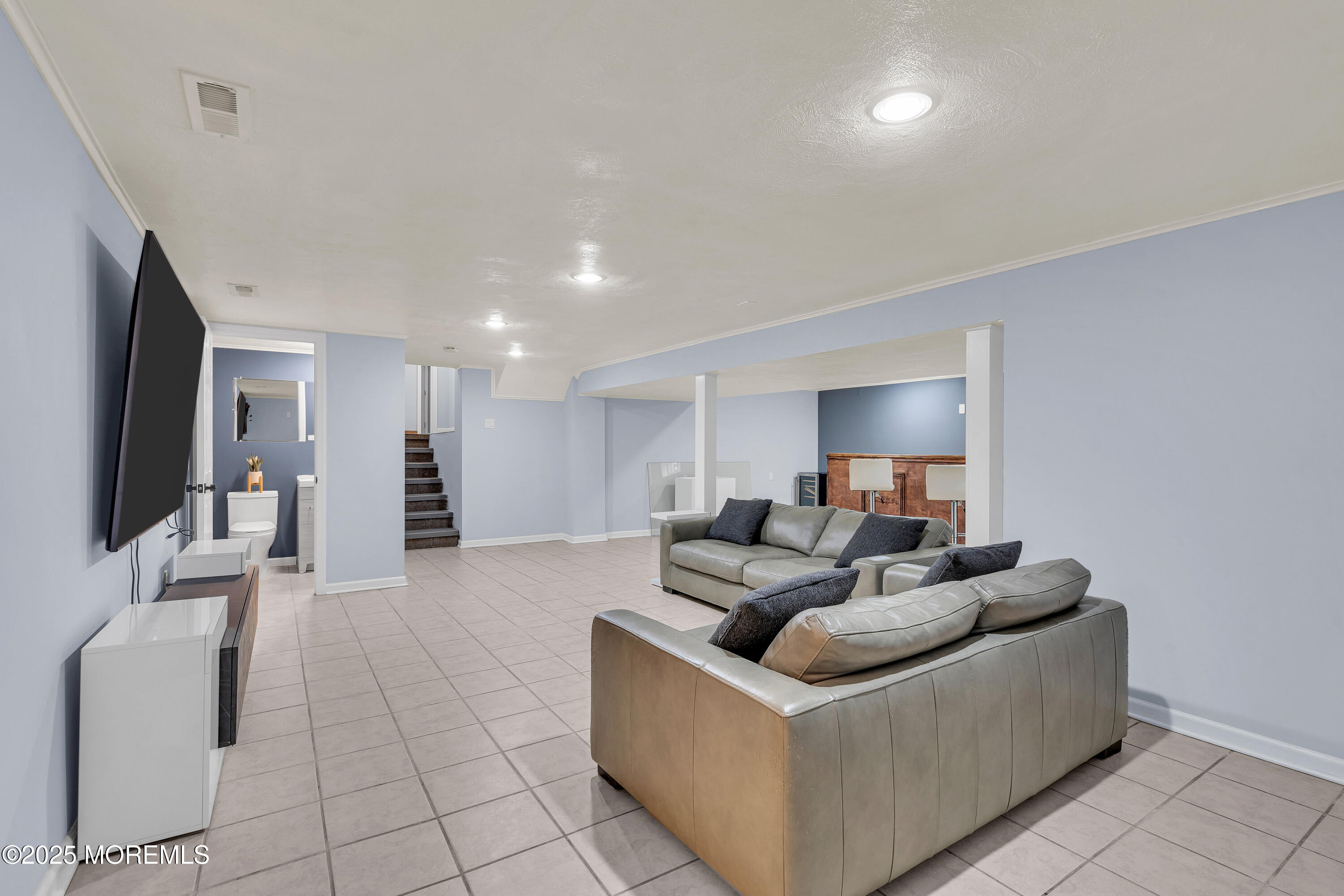 67 Beverly Road Springfield, NJ 07081 - Photo 36 of 46 a living room with furniture and a flat screen tv