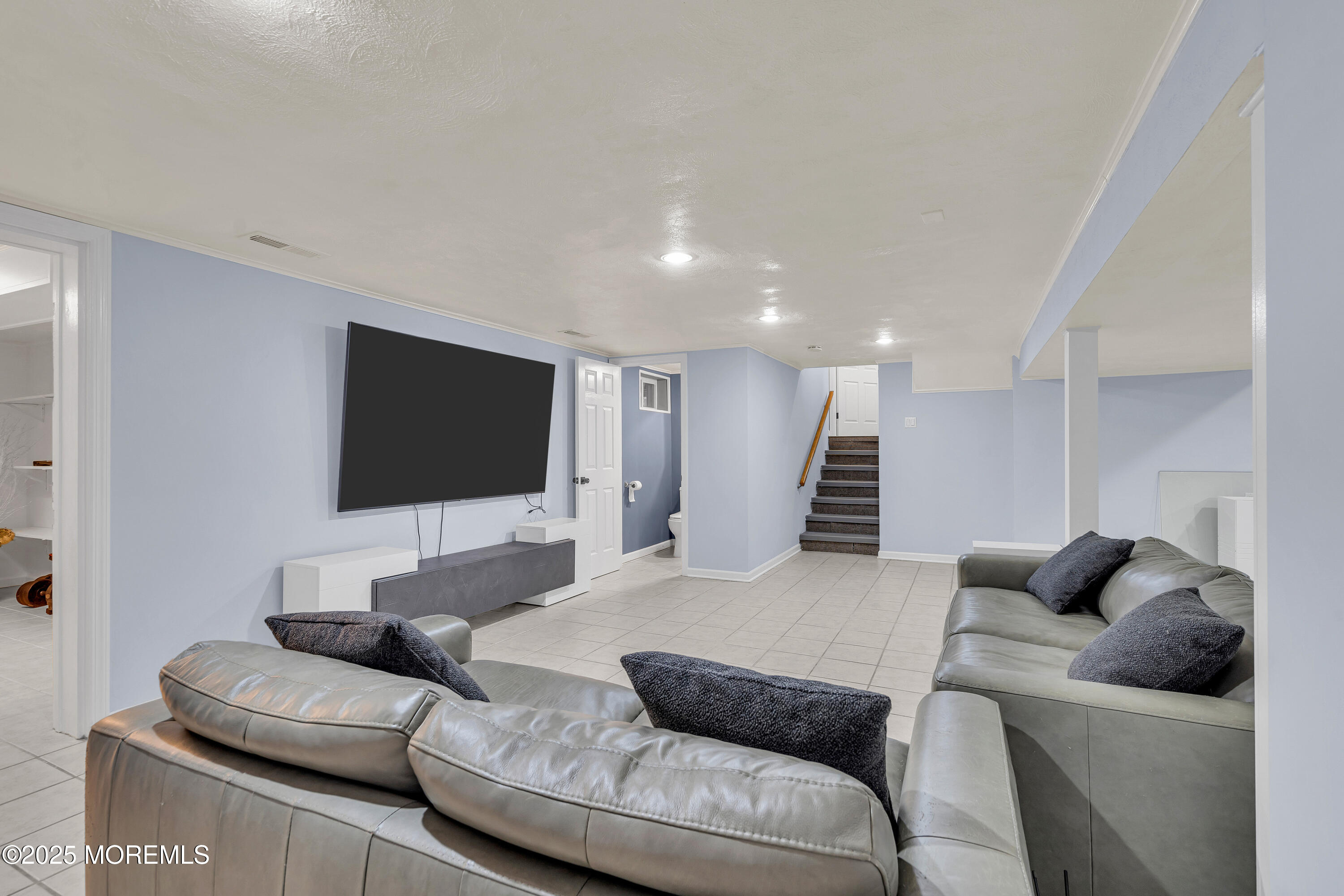 67 Beverly Road Springfield, NJ 07081 - Photo 37 of 46 a living room with furniture and a flat screen tv