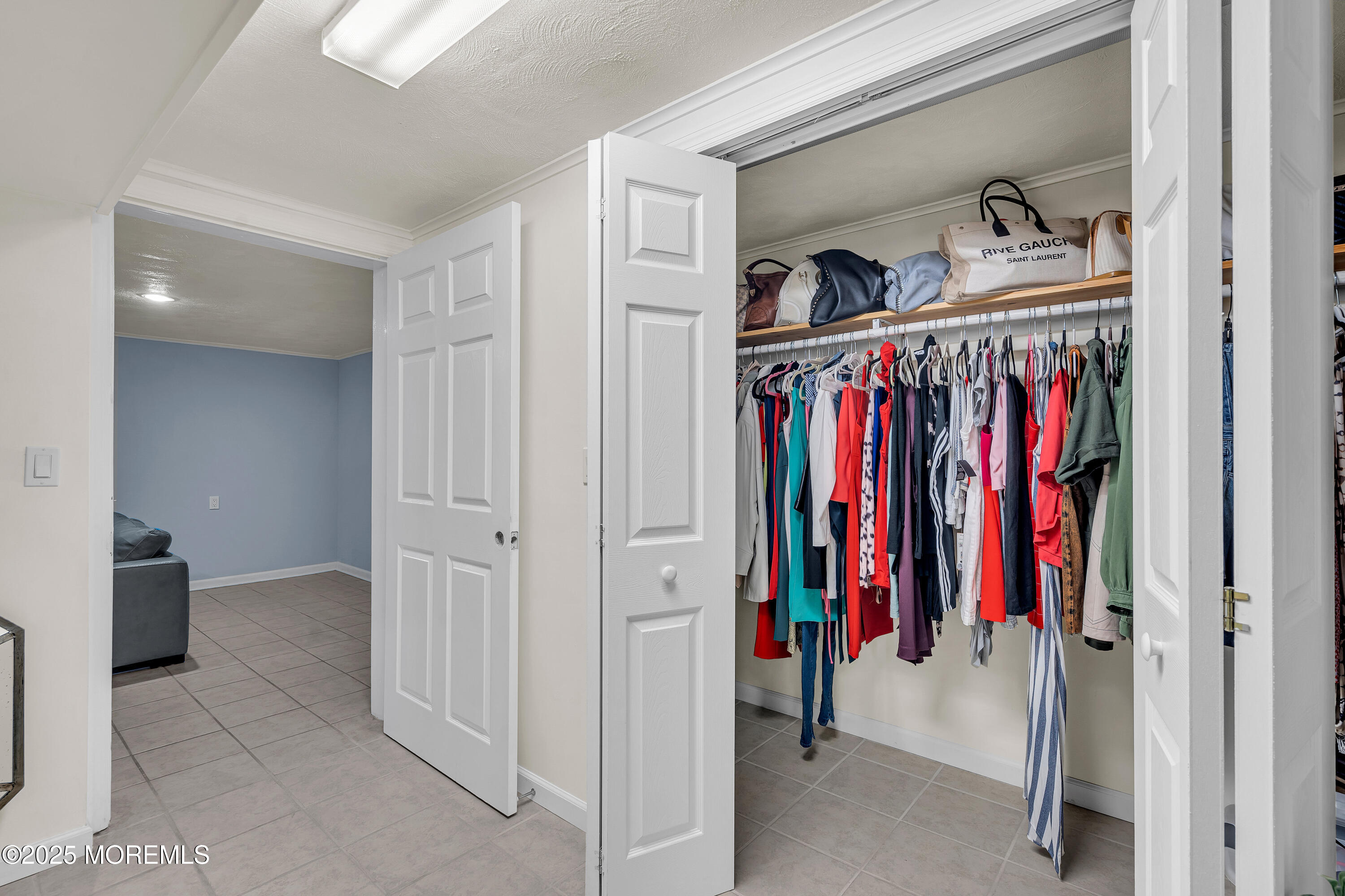 67 Beverly Road Springfield, NJ 07081 - Photo 39 of 46 a view of walk in closet with clothes and shoes