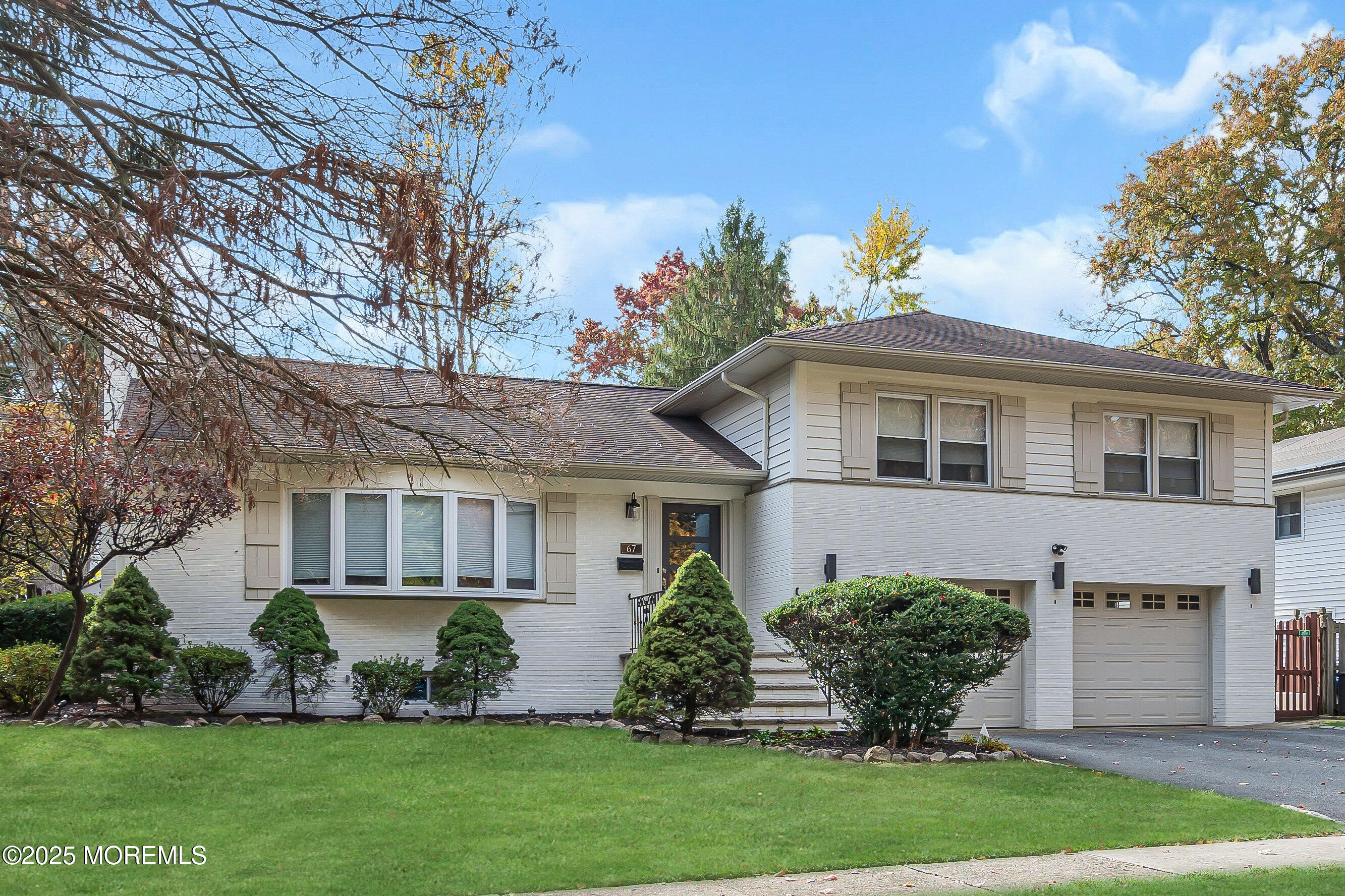 67 Beverly Road Springfield, NJ 07081 - Photo 4 of 46 a front view of a house with a garden and plants