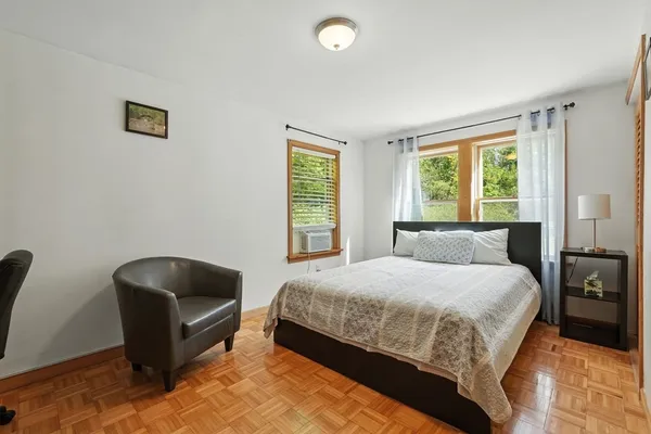 a bedroom with a bed and a chair