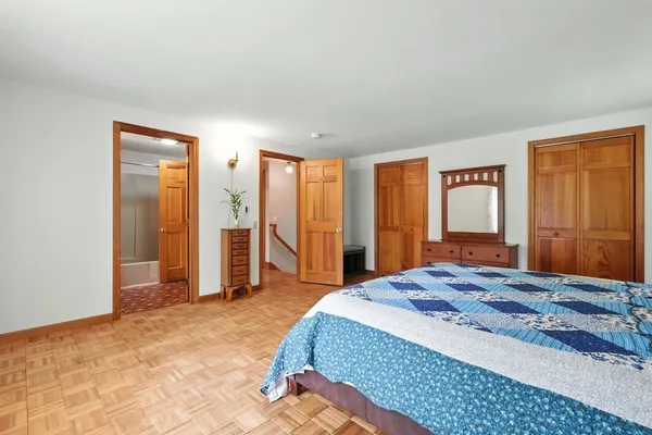 a bedroom with a large bed and a dresser