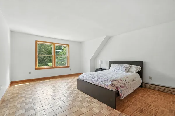 a bedroom with a bed and a window