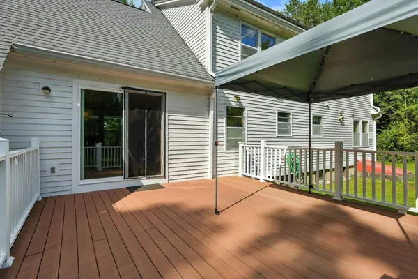 a view of backyard with a deck and wooden floor