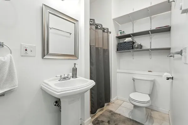 a white toilet sitting next to a bathroom sink