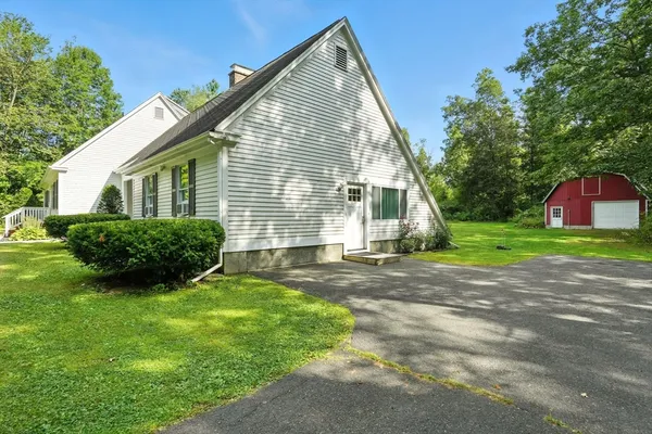 a view of a house with a yard and garage