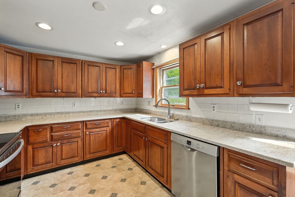 178 West Pomeroy Lane Amherst, MA 01002 - Photo 7 of 34 a kitchen with stainless steel appliances granite countertop a sink dishwasher stove and cabinets with wooden floor