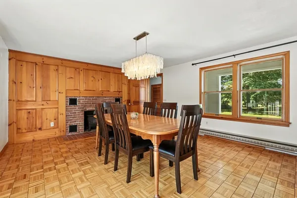 a dining room with furniture a chandelier and window