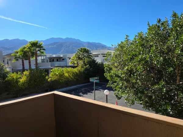 a view of a balcony with a table and a chair