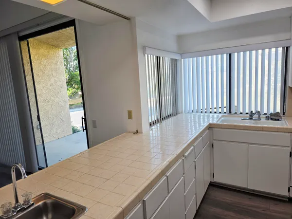 a kitchen with a sink and a large window