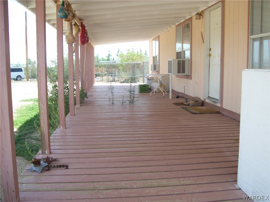 3905 Araby Road Golden Valley, AZ 86413 - Photo 5 of 29 a hallway with a floor to ceiling window and wooden floor