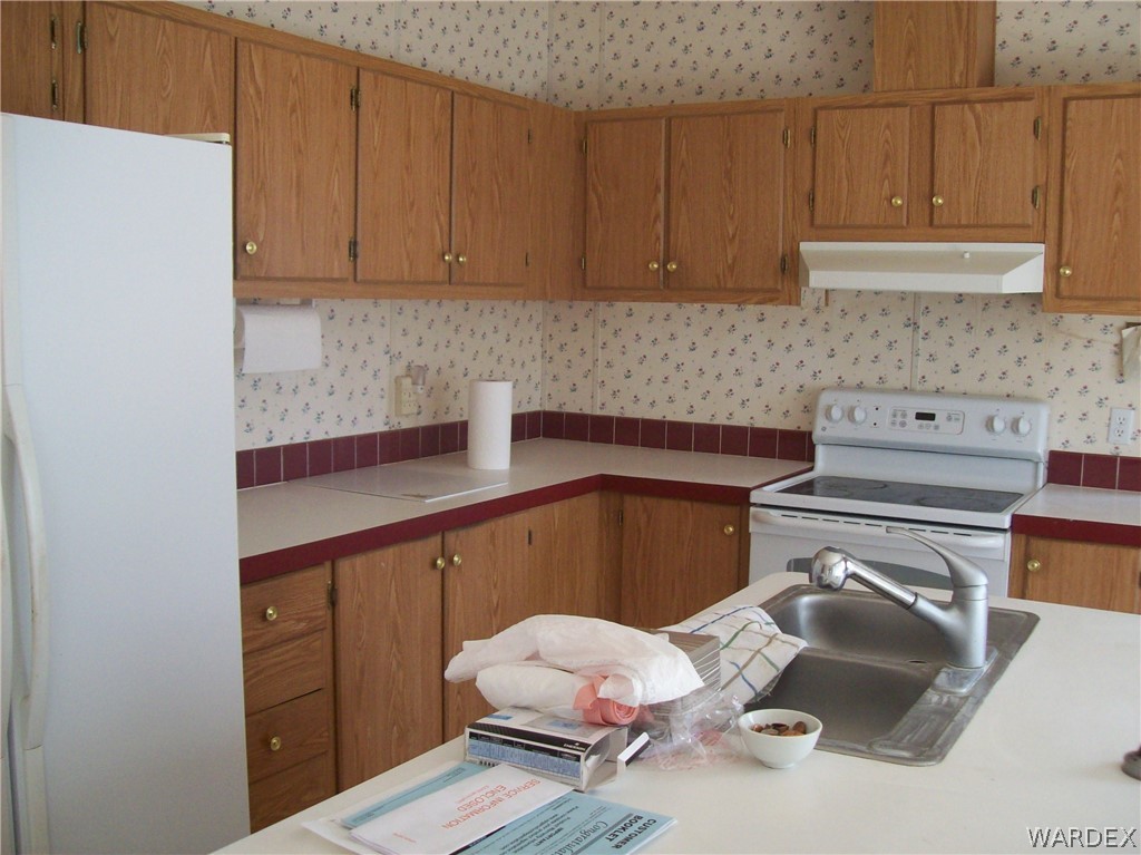 3905 Araby Road Golden Valley, AZ 86413 - Photo 9 of 29 a kitchen with a sink cabinets and utility