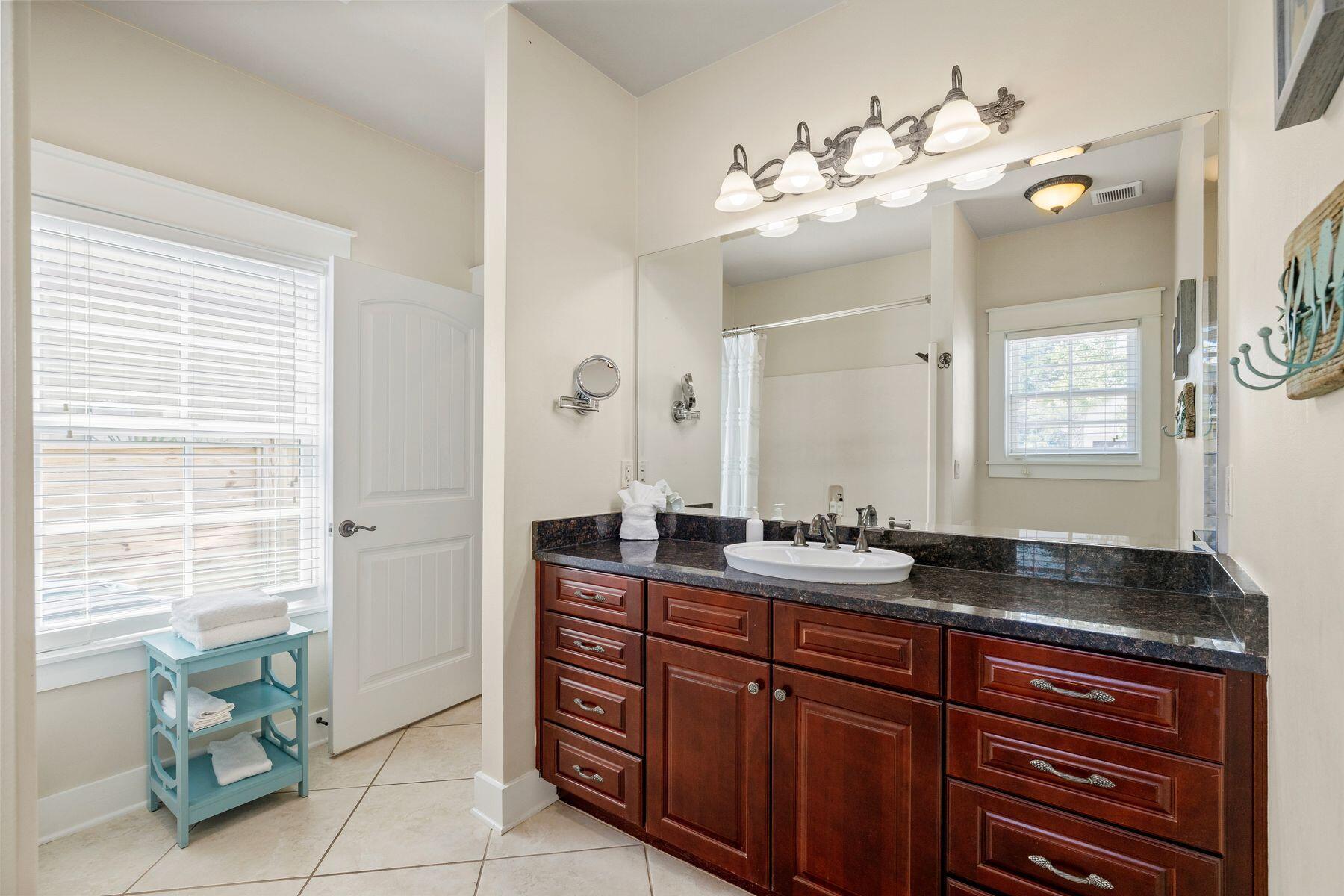 39 Willow Mist Road Inlet Beach, FL 32461 - Photo 15 of 41 a bathroom with a granite countertop sink a large mirror and a window