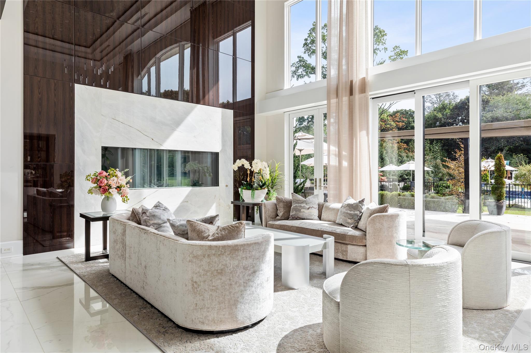 53 Simonson Road Glen Head, NY 11545 - Photo 12 of 43 a living room with couches a coffee table and a large window with garden view