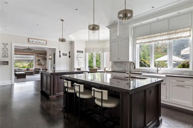 a spacious bathroom with a double vanity sink a large mirror and a bathtub