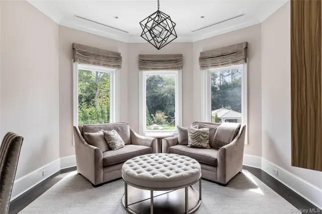 a living room with couches and a flat screen tv