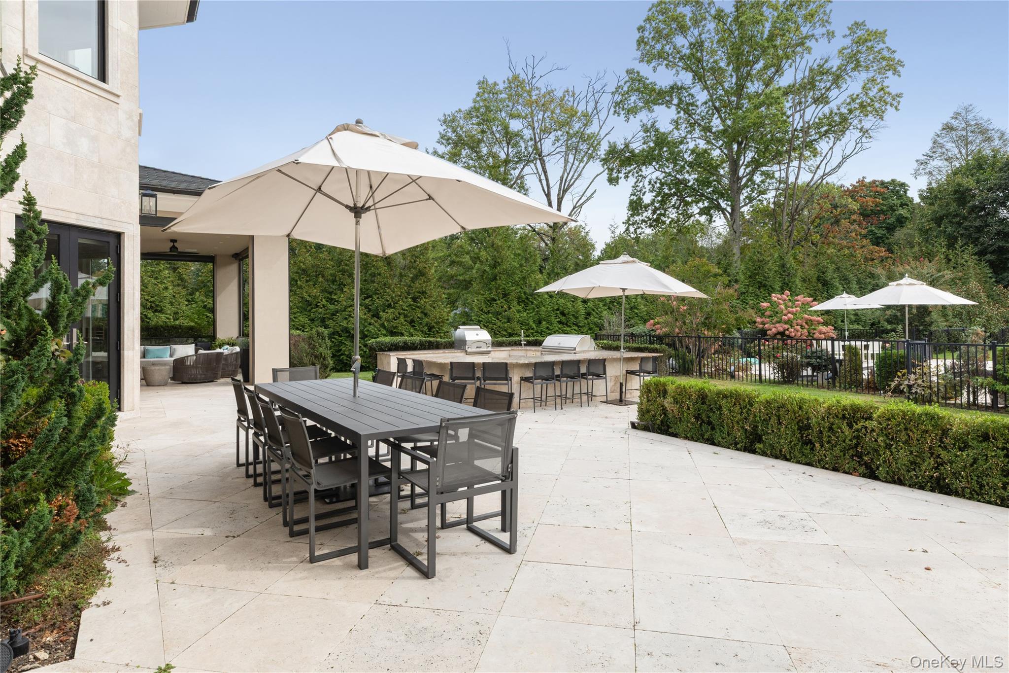 53 Simonson Road Glen Head, NY 11545 - Photo 37 of 43 a view of a patio with a table and chairs under an umbrella