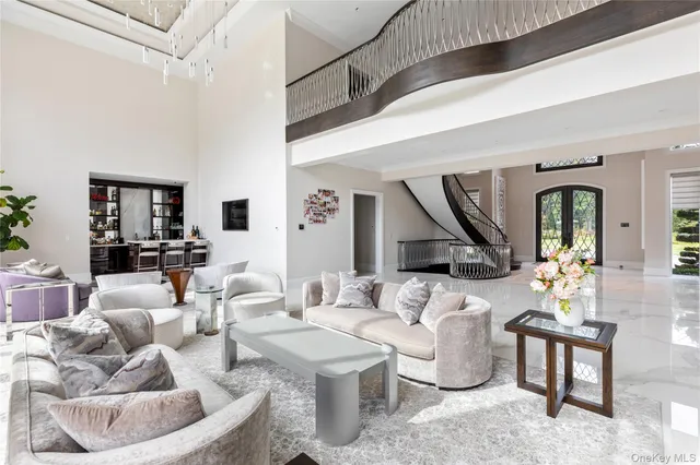 a living room with furniture and large windows