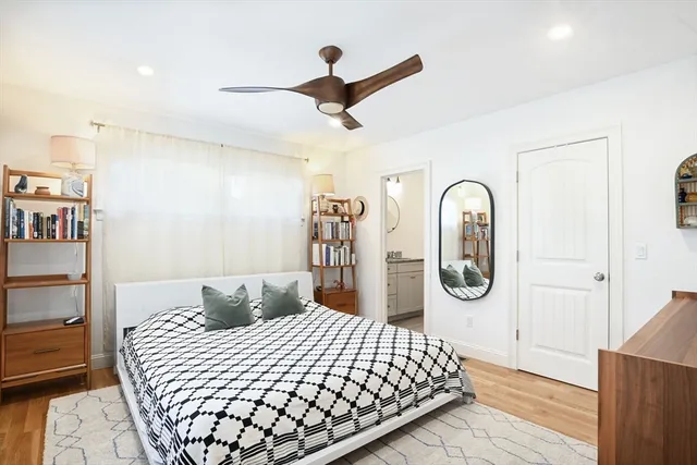 a bedroom with a large bed and a chandelier