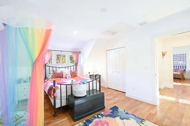 a bedroom with furniture and a wooden floor