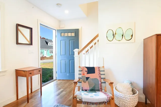 a living room with furniture and a painting on the wall