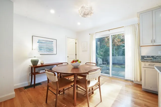 a dining room with furniture and wooden floor