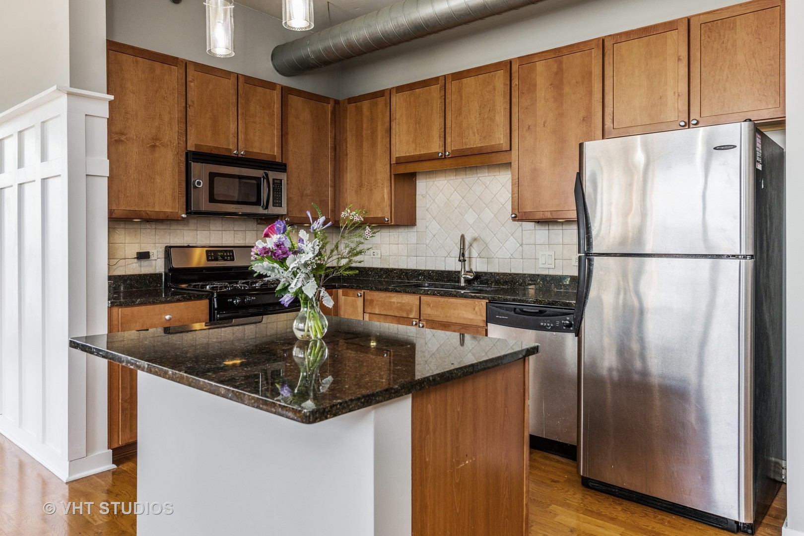 901 West Madison Street, Unit 407 Chicago, IL 60607 - Photo 4 of 11 a kitchen with stainless steel appliances granite countertop a refrigerator a sink and a stove
