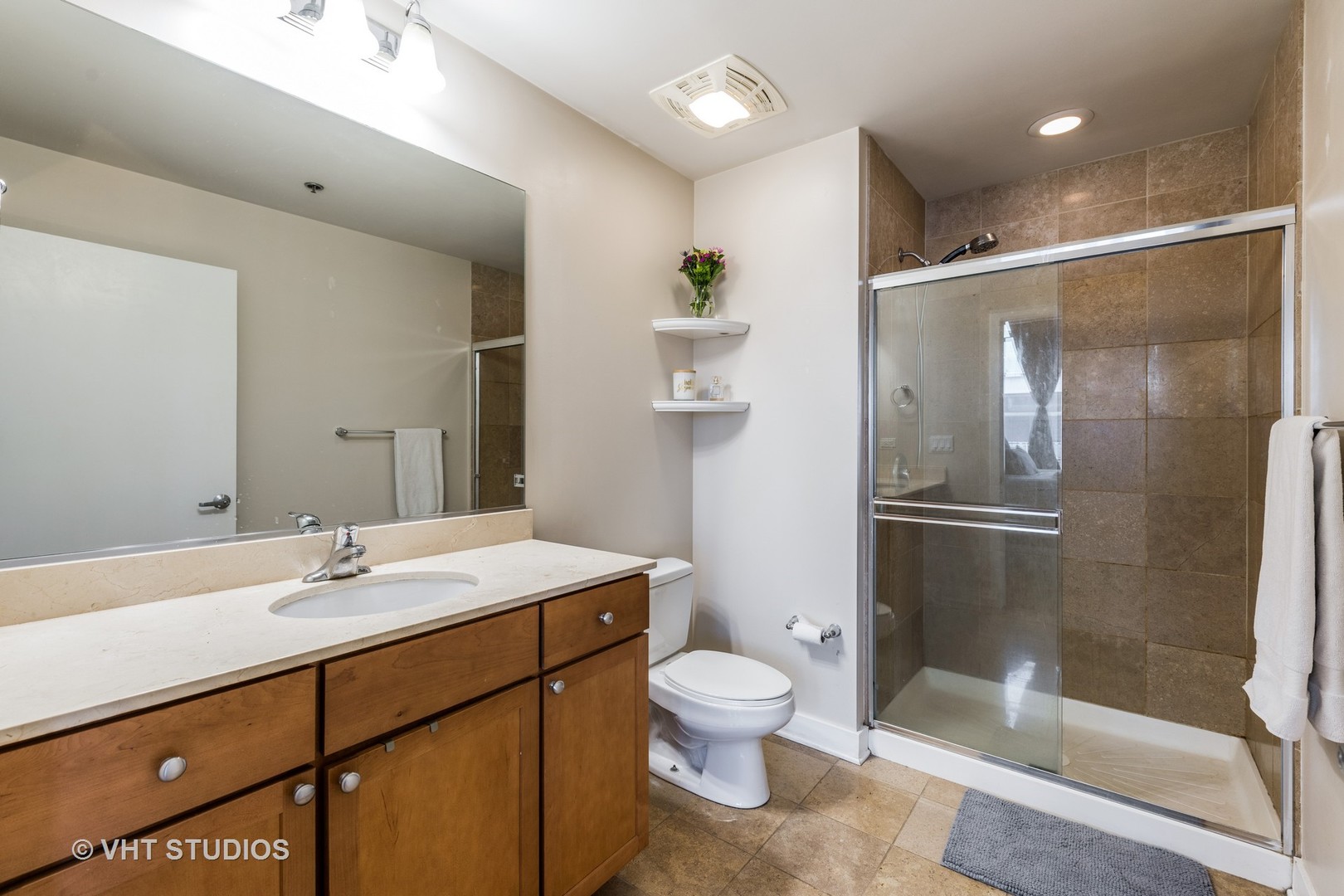 901 West Madison Street, Unit 407 Chicago, IL 60607 - Photo 6 of 11 a bathroom with a sink toilet and shower