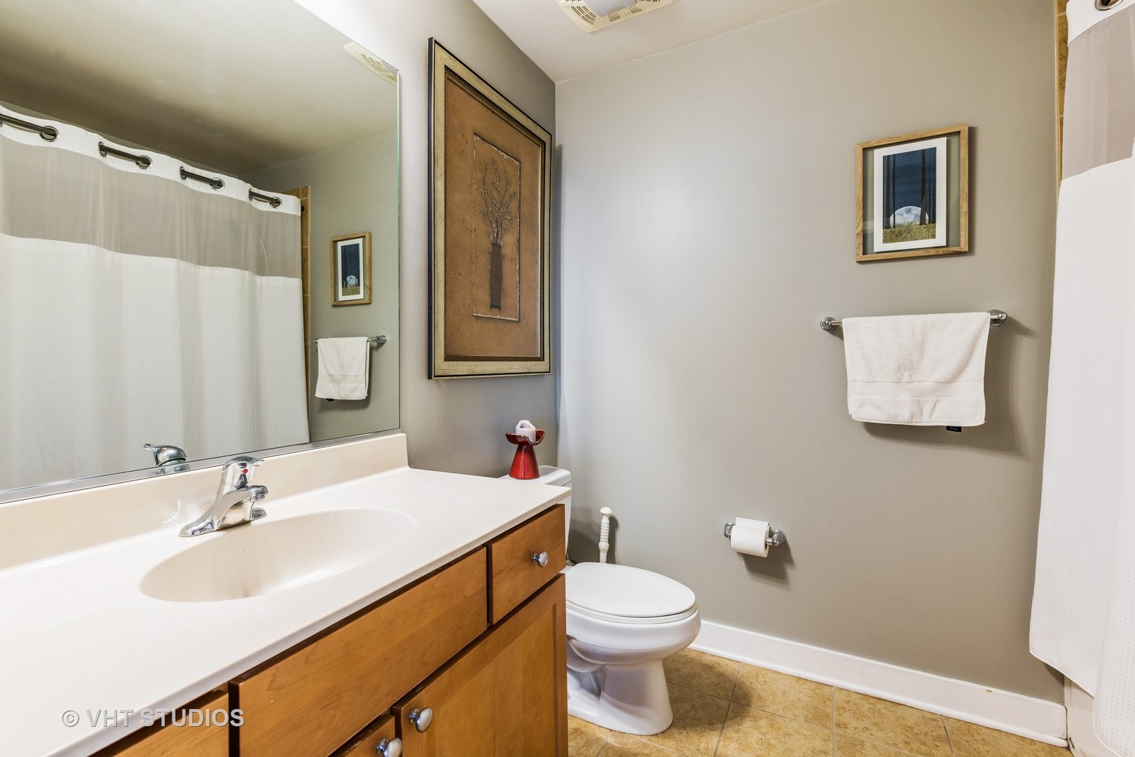 901 West Madison Street, Unit 407 Chicago, IL 60607 - Photo 8 of 11 a bathroom with a sink mirror vanity and toilet