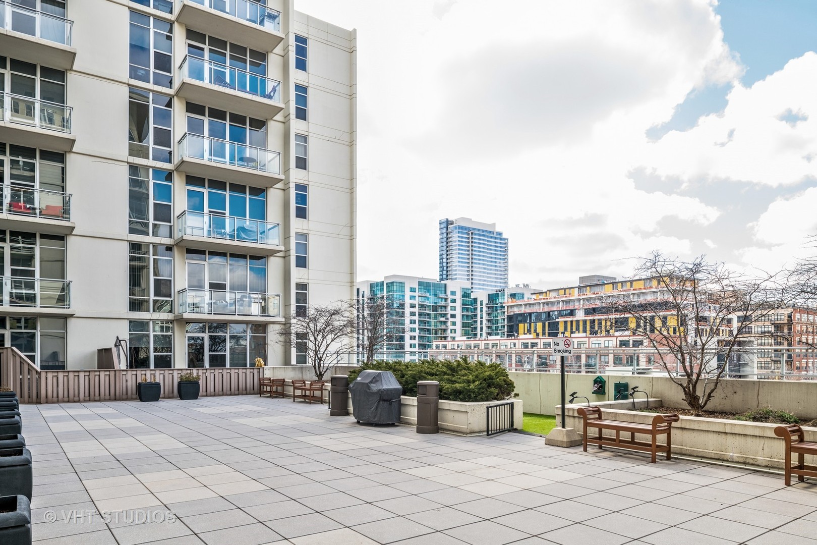 901 West Madison Street, Unit 407 Chicago, IL 60607 - Photo 10 of 11 a view of roof deck with a barbeque and wooden stairs